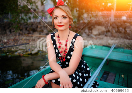 Beautiful young woman dressed dressed in a boat 40669633