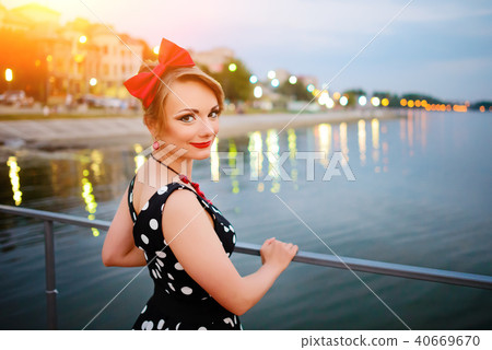 A beautiful young woman dressed stand on the 40669670