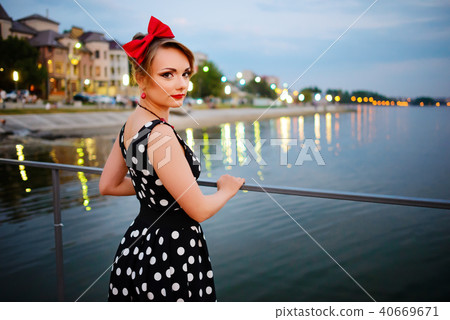 A beautiful young woman dressed stand on the  40669671