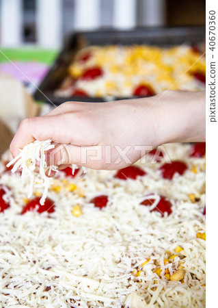 Happy little boy preparing pizza Happy little boy preparing pizza 40670360