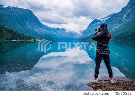 Nature photographer tourist with camera shoots   40670531