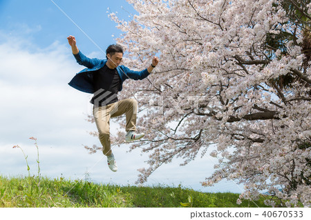 Men jumping back to cherry blossoms Men jumping back to cherry blossoms 40670533