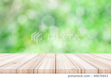 Empty wooden table top with blurred green garden. 40670841