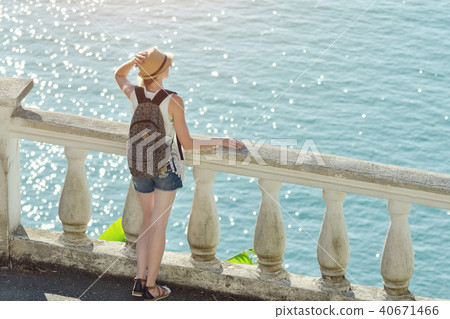 Girl in hat standing on the balcony Girl in hat standing on the balcony 40671466
