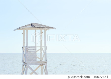 A white wooden lookout lifeguard tower.  40672641