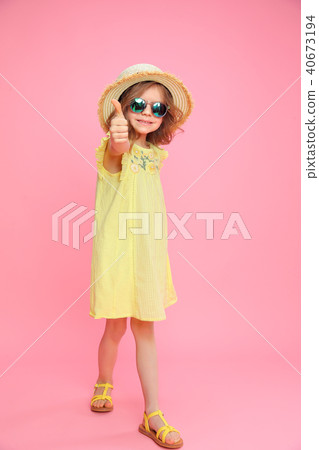 Charming stylish girl showing thumb up on pink 40673194