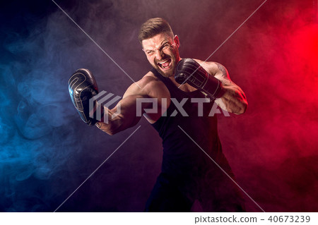 Sportsman muay thai boxer fighting on black background with smoke. Sportsman muay thai boxer fighting on black background with smoke. 40673239