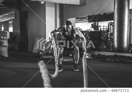 Men with rope in functional training gym Men with rope in functional training gym 40673713