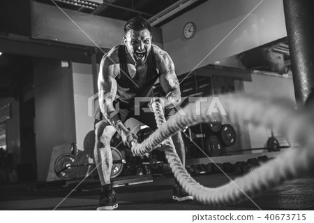 Men with rope in functional training gym Men with rope in functional training gym 40673715