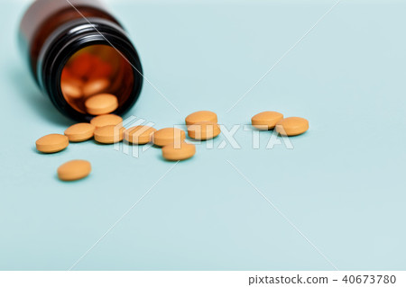 Pills spilling out of pill bottle Pills spilling out of pill bottle 40673780