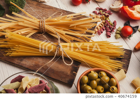 Pasta and cooking ingredients on white wood 40674159