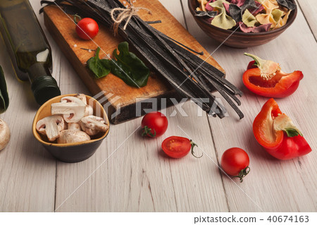 Colorful pasta and cooking ingredients on white wood 40674163