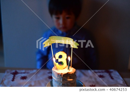Child's 3 year old birthday / blow out a birthday cake candle 40674253