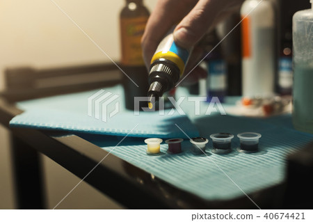 Tattoo ink poured into small caps 40674421