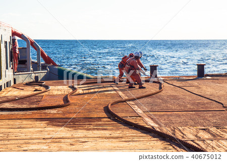 AHTS vessel doing static tow tanker lifting. Ocean tug job AHTS vessel doing static tow tanker lifting. Ocean tug job 40675012