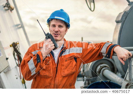 Marine Deck Officer or Chief mate on deck of ship with VHF radio 40675017