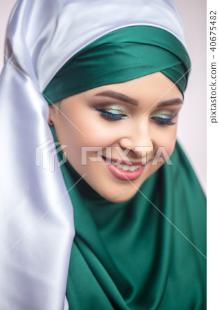 close up portrait of pleasant model in hijab looking down close up portrait of pleasant model in hijab looking down 40675482