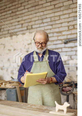 nice pensioner is drawing a graph in the home workshop nice pensioner is drawing a graph in the home workshop 40675498