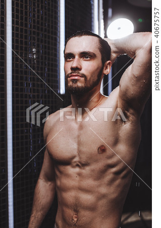 relaxation in the bath.strong serios man demonstrating his body relaxation in the bath.strong serios man demonstrating his body 40675757