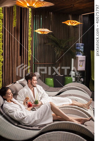 close up portrait of two laughing people in the spa room 40675797