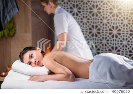 close up shot having rest client with female masseur on the black background close up shot having rest client with female masseur on the black background 40676030
