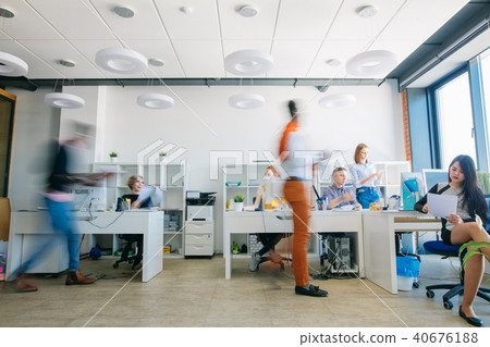 silhouettes of active workers at workplace 40676188