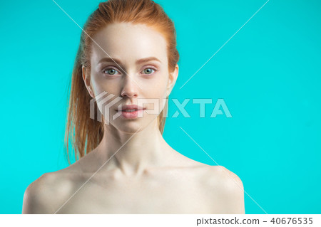 Caucasian female model with ginger hair posing at studio 40676535