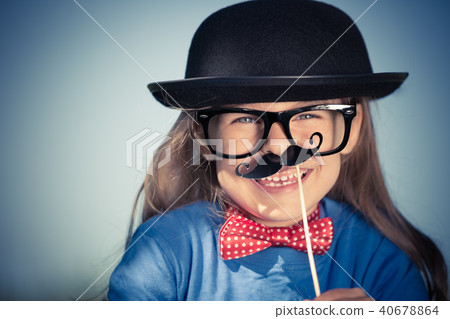 Funny happy little girl in bow tie and bowler hat. Funny happy little girl in bow tie and bowler hat. 40678864