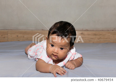cute asian baby lying on bed 40679454