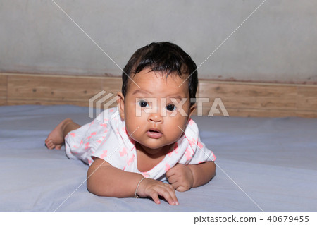 cute asian baby lying on bed 40679455