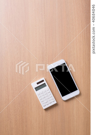 White smartphone and calculator White smartphone and calculator 40684846