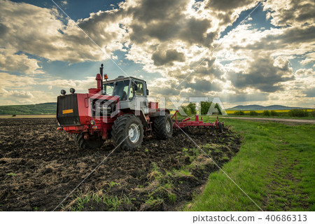 Tractor plowing fields. Tractor plowing fields. 40686313