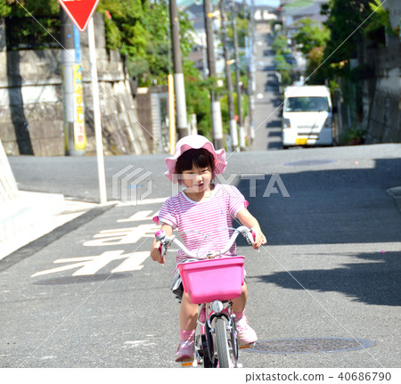 A girl riding a bicycle 40686790