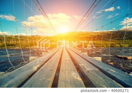 hanging bridge over a mountain river 40688271