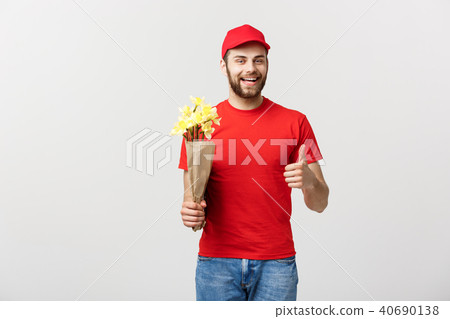 Delivery Concept: Portrait of happy flower delivery man holding beautiful bouquet flower and showing Delivery Concept: Portrait of happy flower delivery man holding beautiful bouquet flower and showing 40690138