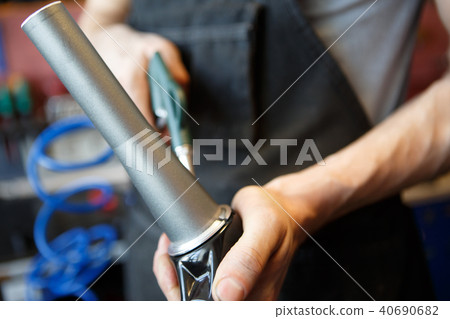 Image of master mending pipe in workshop Image of master mending pipe in workshop 40690682