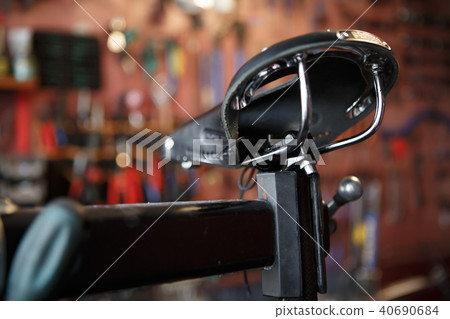 Photo of close-up of bicycle seat in workshop. Photo of close-up of bicycle seat in workshop. 40690684