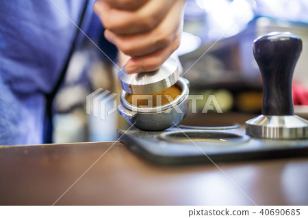 Image of barista man with mortar with coffee Image of barista man with mortar with coffee 40690685