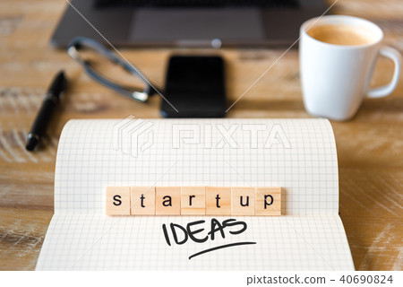 Wooden blocks with letters STARTUP IDEAS text 40690824