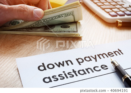 Down payment assistance form and dollar banknotes. Down payment assistance form and dollar banknotes. 40694191