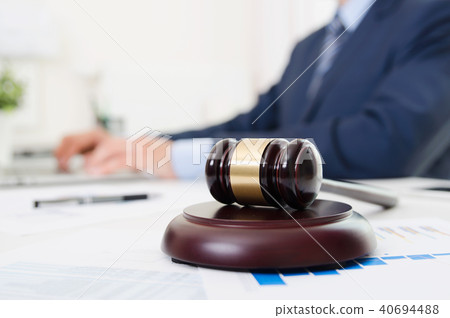 Wooden gavel on table. Attorney working in office Wooden gavel on table. Attorney working in office 40694488