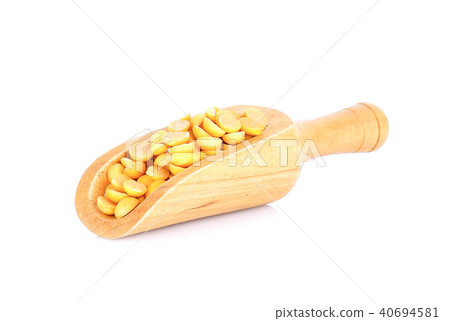 Yellow beans seeds in wood scoop on white Yellow beans seeds in wood scoop on white 40694581