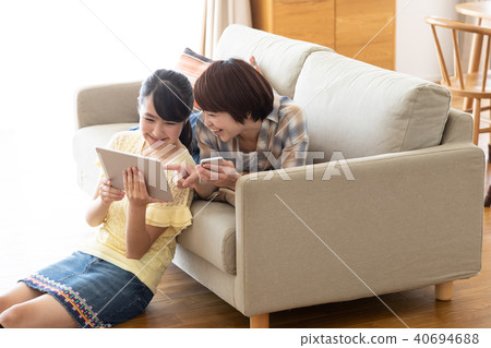 Parents and children watching tablet on the sofa Parents and children watching tablet on the sofa 40694688