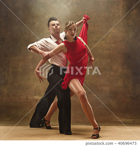 Flexible young modern dance couple posing in studio. 40696473
