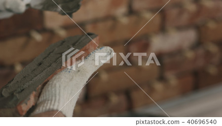 closeup worker applying concrete glue to brick cuts tile closeup worker applying concrete glue to brick cuts tile 40696540