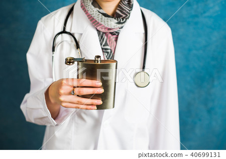 Doctor holding a hip flask close up Doctor holding a hip flask close up 40699131