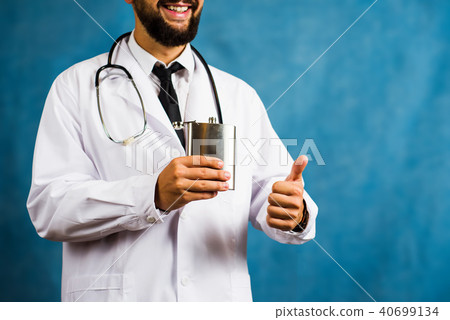 Doctor holding a hip flask close up Doctor holding a hip flask close up 40699134