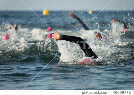 Group people in wetsuit swimming at triathlon 40699776