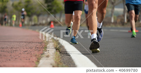 Marathon running race, people feet on city road 40699780