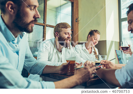 Team job while relaxing in pub. Team job while relaxing in pub. 40700753